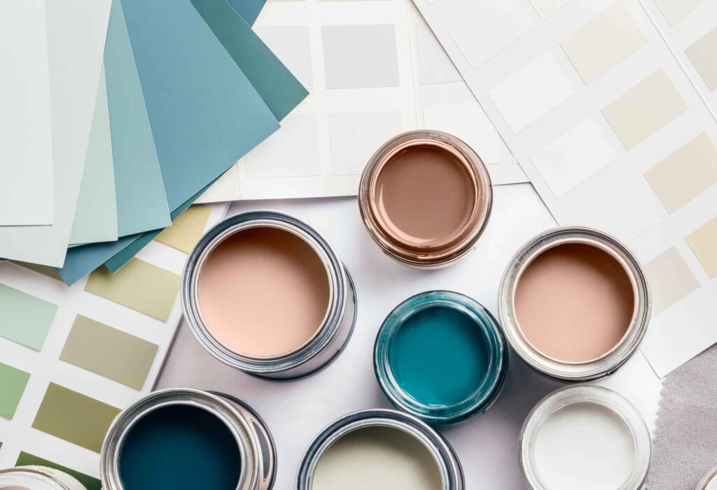 Color palettes and paints on a table.