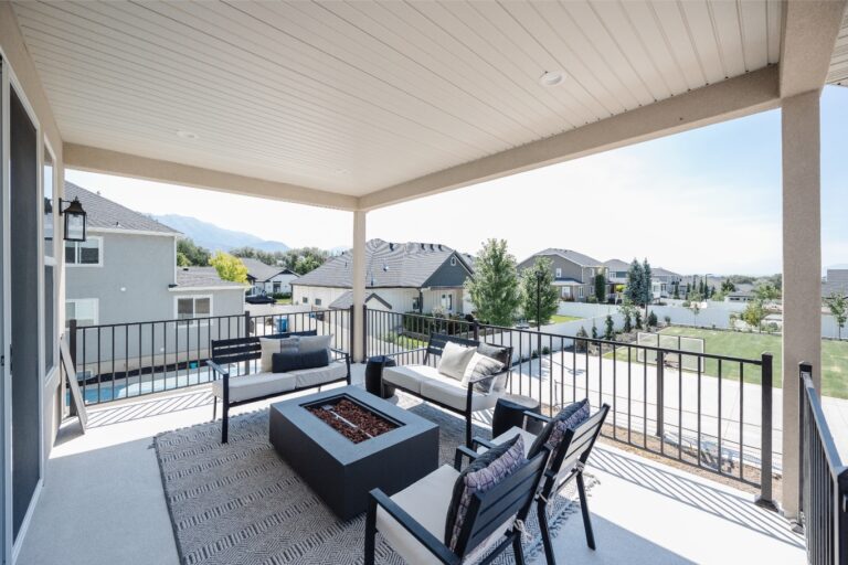 The image is a digitally altered photo of an outdoor patio area with white walls and blue sky.