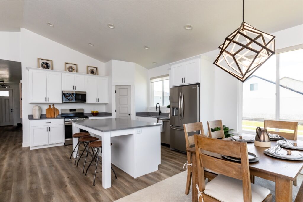 The room is white and has a dining table with chairs.