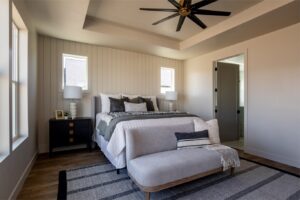 The room is empty and appears to be a bedroom with white walls and ceiling fan.