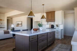 The room is a kitchen with white walls and brown furniture.
