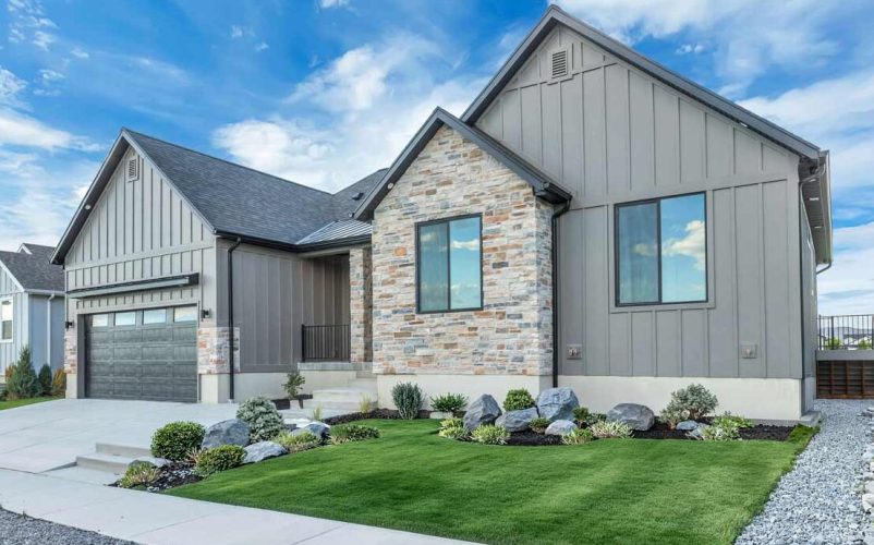 A beautifully designed modern exterior of a Narwhal home featuring clean lines, premium siding, and professional landscaping under a clear Utah sky. This image showcases the inviting curb appeal and thoughtful craftsmanship that defines our architectural style, highlighting the perfect balance between comfort and contemporary elegance.